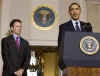 President Barack Obama leaves the Blue Room of the White House and speaks in the Grand Foyer with Treasury Secretary Timothy Geithner. Obama advises that any financial institution that requires a bailout will cap executive salaries at $500,000 per year.