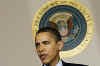 President Barack Obama leaves the Blue Room of the White House and speaks in the Grand Foyer with Treasury Secretary Timothy Geithner. Obama advises that any financial institution that requires a bailout will cap executive salaries at $500,000 per year.