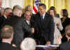 President Barack Obama signs the $32.8 billion State Children's Health Insurance Program in the East Room of the White House on February 4, 2009.