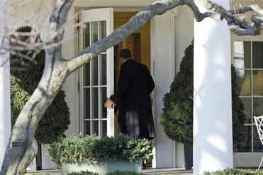 President Barack Obama returns to the Oval Office of the White house after the National Prayer Breakfast on February 5, 2009.