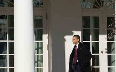 President Barack Obama returns to the Oval Office of the White house after the National Prayer Breakfast on February 5, 2009.