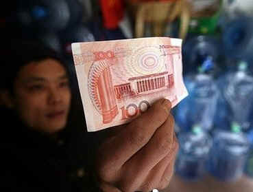 President Barack Obama recently suggested that China was manipulating the US currency. Barack Obama makes his first call as President to Chinese President Hu Jintao. The leaders discussed being more positive in their relations and China said the US must avoid trade protectionism. Photo: Man holds a 100-Yuan note.