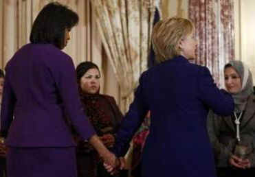 First Lady Michelle Obama and Secretary of State Hillary Clinton join in presenting the Secretary of State's International Women of Courage awards to women recipients from around the world on March 11, 2009.
