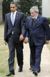 President Barack Obama escorts Da Silva across the South Lawn of the White House to a waiting limousine.