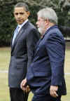 President Barack Obama escorts Da Silva across the South Lawn of the White House to a waiting limousine.