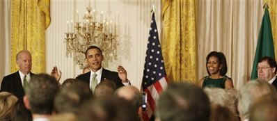 President Barack Obama, First Lady Michelle Obama, and Vice President Joe Biden join Irish Prime Minister Brian Cowen and leaders from Northern Ireland for a St. Patrick's Day reception in the East Room of the White House on March 17, 2009.