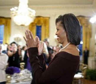 First Lady Michelle Obama hosts a dinner in the East Room of the White House to celebrate Women's History Month.