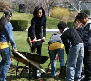 First Lady Michelle Obama plants a White House Kitchen Garden with the help of 5th graders from Bancroft Elementary School in Washington DC. 