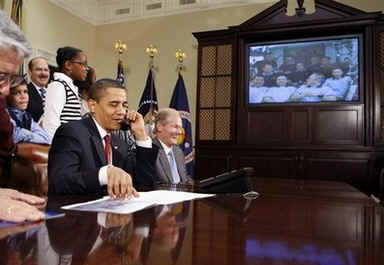 President Barack Obama, members of Congress, and local students speak to the astronauts on the International Space Station and the Shuttle Discovery crew from the Roosevelt Room of the White House on March 23, 2009.