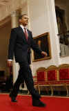 President Obama walks down the Cross Hall to media event. President Obama holds a one-hour live prime time news conference in the East Room of the White House on March 24, 2009.