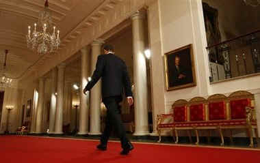 President Obama walks down the Cross Hall after media event. President Obama holds a one-hour live prime time news conference in the East Room of the White House on March 24, 2009.