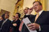 President Obama's staff listen at media event. President Obama holds a one-hour live prime time news conference in the East Room of the White House on March 24, 2009.