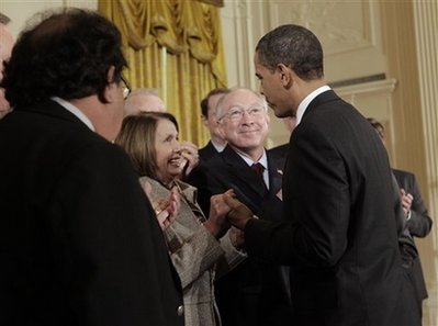 President Barack Obama signs the Omnibus Public Lands Management Act in the East Room of the White House on March 30, 2009. House Speaker Nancy Pelosi and other government officials joined President Obama for the signing.