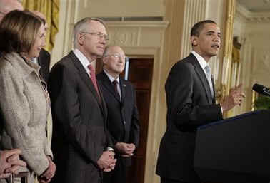 President Barack Obama signs the Omnibus Public Lands Management Act in the East Room of the White House on March 30, 2009. House Speaker Nancy Pelosi and other government officials joined President Obama for the signing.