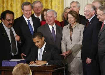 President Barack Obama signs the Omnibus Public Lands Management Act in the East Room of the White House on March 30, 2009. House Speaker Nancy Pelosi and other government officials joined President Obama for the signing.