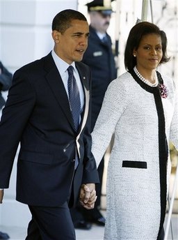President Barack Obama and First Lady Michelle Obama walk across the South Lawn of the White House to board Marine One for a trip to Andrews Air Force Base where they will depart on Air Force One for a one-week European trip.