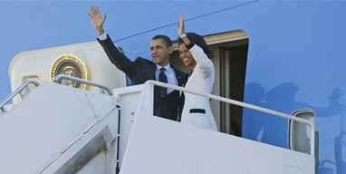 President Barack Obama and First Lady Michelle Obama walk across the South Lawn of the White House to board Marine One for a trip to Andrews Air Force Base where they will depart on Air Force One for a one-week European trip.