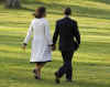 President Barack Obama and First Lady Michelle Obama walk across the South Lawn of the White House to board Marine One for a trip to Andrews Air Force Base where they will depart on Air Force One for a one-week European trip.