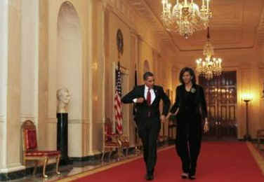 President Barack Obama and First Lady Michelle Obama in the Cross Hall on their way to a dinner for Congressional Heads in the East Room of the White House on March 4, 2009.