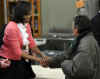 First Lady Michelle Obama speaks and serves meals at Miriam's Kitchen.