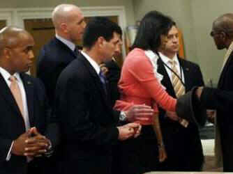 Under heavy Secret Service guard, First Lady Michelle Obama speaks and serves food at Miriam's Kitchen.