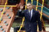 President Barack Obama leaves the White House and passes by the new outdoor play set purchased for Sasha and Malia.