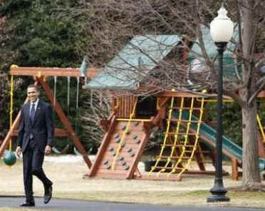 President Barack Obama leaves the White House and passes by the new outdoor play set purchased for Sasha and Malia.