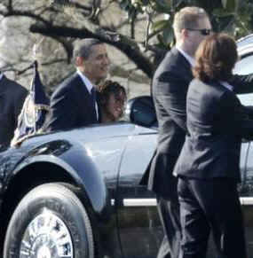 President Obama and daughter Malia take a ride in the presidential limo enroute to a parent teacher meeting for Sasha at Sidwell School in Bethesda, Maryland.