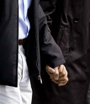 President Barack Obama and First Lady Michelle Obama walk across the South Lawn of the White House holding hands as they depart for an overnight stay with family at the presidential retreat at Camp David on March 7, 2009.