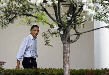 President Barack Obama walks in the colonnade of the White House on his wat to the Easter Egg Roll event.