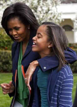 Michelle walks with daughter Malia at White House Easter event.