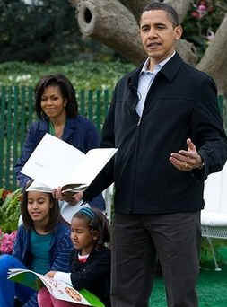 President Obama reads and acts out from the book 'Where the Wild Things Are' to a group of children.