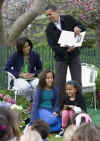 President Obama reads and acts out from the book 'Where the Wild Things Are' to a group of children.