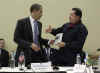 President Obama is given a book prior to the start of the meeting by Venezuelan President Hugo Chavez. The book written in Spanish is titled The Open Veins of Latin America.