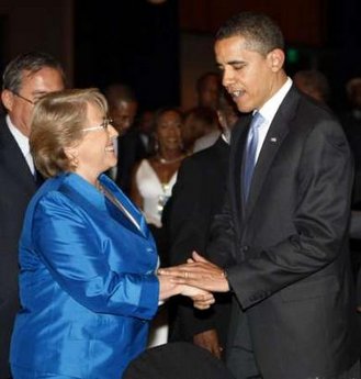 President Obama played the gentleman and assisted Chile's President Bachelet to her seat.