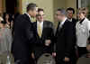 President Obama greets El Salvador's President-elect Funes.