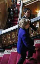 Secretary of State Hillary Clinton and UK Foreign Minister Miliband on their way to a joint news conference in the Foreign and Commonwealth Office building in London.