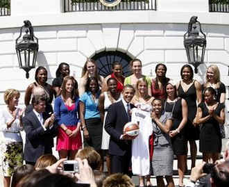 President Obama is given a custom jersey and basketball by the women's championship team.