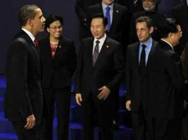 President Obama walked on the stage and walked directly to PM Harper to tease him about his absence from the original group photo.