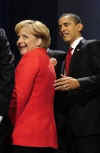 President Obama escorted German chancellor Angela Merkel from the stage after making gestures during the first G20 group photo.