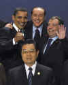 President Obama gestures during the group photo with Russian President Medvedev and Italian Prime Minister Berlusconi.