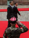 President Barack Obama walks by a military honor guard in the palace courtyard and partakes in a welcoming ceremony.