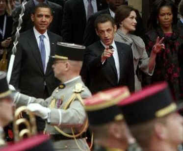 President Barack Obama walks by a military honor guard in the palace courtyard and partakes in a welcoming ceremony.