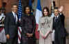 US President Barack Obama and First Lady Michelle Obama pose with French President Sarkozy and French First Lady Carla Bruni-Sarkozy on the steps of the Palais Rohan.