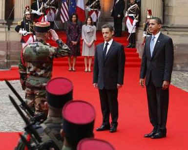 President Barack Obama walks by a military honor guard in the palace courtyard and partakes in a welcoming ceremony.