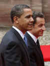 President Barack Obama walks by a military honor guard in the palace courtyard and partakes in a welcoming ceremony.