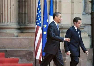 President Barack Obama and First Lady Michelle Obama say goodbye to the waiting crowds and President Sarkozy.