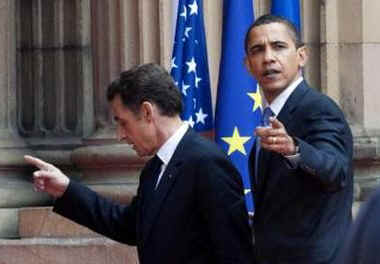 President Barack Obama and First Lady Michelle Obama say goodbye to the waiting crowds and President Sarkozy.