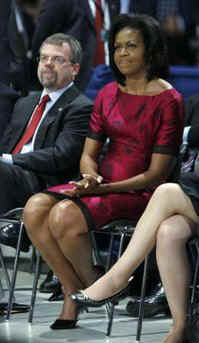 First Lady Michelle Obama listens to the President speak at a town hall style meeting with a young German and French audience at the Rhenus Sports Arena in Strasbourg, France. 