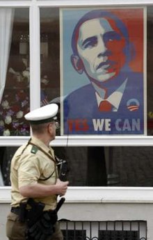 Police officer looks at the Obama poster as he walks in the Baden-Baden market area prior to Obama's arrival on April 3, 2009.